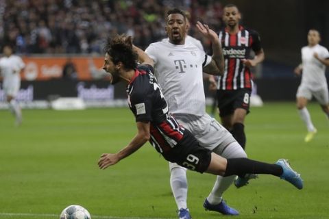 Frankfurt's Goncalo Paciencia is fouled by Bayern's Jerome Boateng, who was shown a yellow card for the tackle and a penalty was given during a German Bundesliga soccer match between Eintracht Frankfurt and Bayern Munich in the Commerzbank Arena in Frankfurt, Germany, Saturday, Nov. 2, 2019. (AP Photo/Michael Probst)