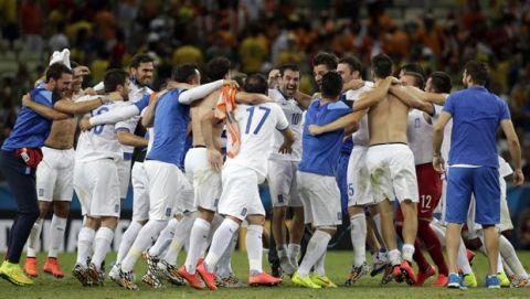 Greek players celebrate their 2-1 win after the group C World Cup soccer match between Greece and Ivory Coast at the Arena Castelao in Fortaleza, Brazil, Tuesday, June 24, 2014. (AP Photo/Fernando Llano)