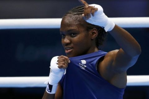 Britain's Nicola Adams celebrates after being declared the winner over India's Chungneijang Mery Kom Hmangte following their Women's Fly (51kg) semi-final boxing match at the London Olympic Games August 8, 2012.    REUTERS/Murad Sezer (BRITAIN  - Tags: SPORT BOXING OLYMPICS)  