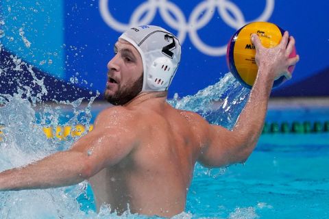 Greece's Konstantinos Genidounias plays against Japan during a preliminary round men's water polo match at the 2020 Summer Olympics, Thursday, July 29, 2021, in Tokyo, Japan. (AP Photo/Mark Humphrey)