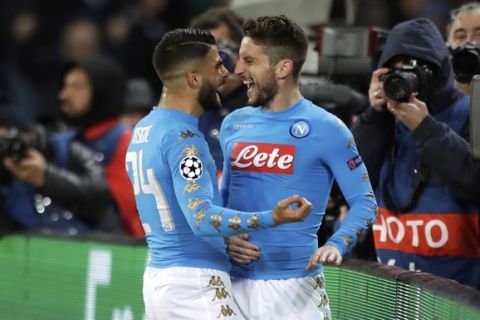 Napoli's Dries Mertens, right, celebrates after scoring the opening goal during the Champions League round of 16, second leg, soccer match between Napoli and Real Madrid at the San Paolo stadium in Naples, Italy, Tuesday March 7, 2017. (AP Photo/Andrew Medichini)