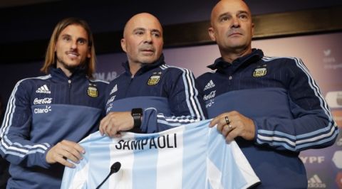 Argentina's new soccer coach Jorge Sampaoli poses between his coaching staff Sebastian Beccacece, left, and Jorge Desio at the end of a press conference in Buenos Aires, Argentina, Thursday, June 1, 2017. (AP Photo/Natacha Pisarenko)