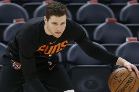 Phoenix Suns guard Jimmer Fredette warms up before the start of their NBA basketball game against the Utah Jazz Monday, March 25, 2019, in Salt Lake City. (AP Photo/Rick Bowmer)