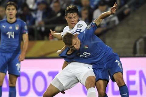 Sauli V'is'nen of Finland, left center, fights for the ball with Nicolo Barella of Italy during the men's football UEFA Euro 2020 European Championships Group J qualifying match Finland vs Italy in Tampere, Finland on Sunday, Sept. 8, 2019. (Markku Ulander/Lehtikuva via AP)