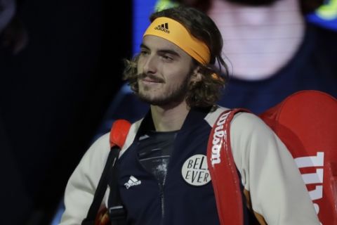 Stefanos Tsitsipas of Greece walks onto court ahead of his match against Austria's Dominic Thiem in their ATP World Finals singles final tennis match at the O2 arena in London, Sunday, Nov. 17, 2019. (AP Photo/Kirsty Wigglesworth)