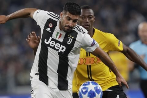 Juventus midfielder Emre Can, left, and Young Boys' Mohamed Ali Camara vie for the ball during the Champions League, group H soccer match between Juventus and Young Boys, at the Allianz stadium in Turin, Italy, Tuesday, Oct. 2, 2018. (AP Photo/Luca Bruno)