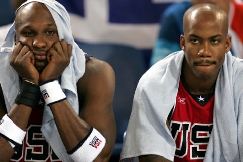 United States players, from left, Lamar Odom and Stephon Marbury sit dejected as their team loses to Puerto Rico during men's basketball tournament preliminary match against Puerto Rico in Hellinikon Sunday, Aug. 15,  2004, during 2004 Olympic Games in Athens. (AP Photo/Dusan Vranic)