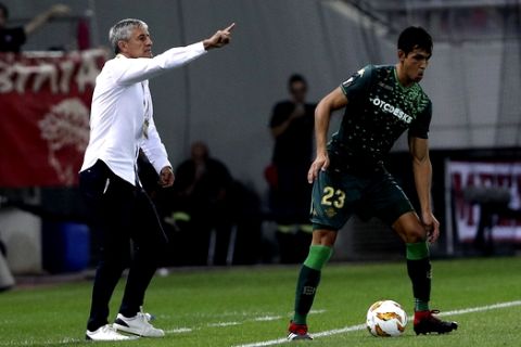 Real Betis coach Enrique Setien Solar gives instructions to his players during a Group F Europa League soccer match between Olympiakos Piraeus and Real Betis at the Karaiskakis Stadium, in Piraeus, near Athens, on Thursday, Sept. 20, 2018. (AP Photo/Petros Giannakouris)