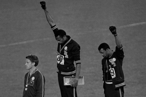 ** FILE ** In this Oct. 16, 1968, file photo, United States athletes Tommie Smith, top center, and John Carlos, top right, extend their gloved fists skyward during the playing of the "Star-Spangled Banner" after Smith received the gold and Carlos the bronze for the 200-meter run at the Summer Olympic Games in Mexico City. Carlos and Smith raised their black-gloved fists on the medals stand as a symbol of protest 40 years ago at the Mexico City Olympics, creating an iconic image from the games. Australia's silver medalist Peter Norman is at left.  (AP Photo/file)