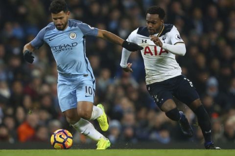 Manchester City's Sergio Aguero, left holds off the challenge of Tottenham Hotspur's Danny Rose during the English Premier League soccer match between Manchester City and Tottenham Hotspur at the Etihad stadium in Manchester, England, Saturday, Jan., 21, 2017. (AP Photo/Dave Thompson)