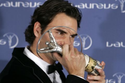 Switzerland's tennis player Roger Federer kisses the trophy after the Laureus Sports Awards ceremony in St. Petersburg, Russia, Monday, Feb. 18, 2008. Federer was named Laureus World Sportsman of the Year, for the fourth straight time.  (AP Photo/Dmitry Lovetsky)