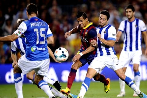 FC Barcelona's Alexis Sanchez, from Chile, third right, duels for the ball against Real Sociedad's Javi Ros, second right, during a Spanish La Liga soccer match at the Camp Nou stadium in Barcelona, Spain, Tuesday, Sept. 24, 2013. (AP Photo/Manu Fernandez)