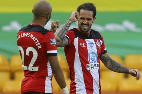 Southampton's Danny Ings, right, celebrates with his teammate Southampton's Nathan Redmond after scoring his side's first goal during the English Premier League soccer match between Norwich City and Southampton at Carrow Road in Norwich, England, Friday, June 19, 2020. (AP Photo/Richard Heathcote/Pool)