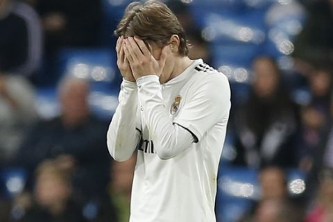 Real Madrid's Luka Modric reads at the end of a Spanish La Liga soccer match between Real Madrid and Real Sociedad at the Santiago Bernabeu stadium in Madrid, Spain, Sunday, Jan. 6, 2019. Real Sociedad beat Real Madrid 2-0. (AP Photo/Paul White)
