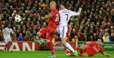 LIVERPOOL, ENGLAND - OCTOBER 22:  Cristiano Ronaldo of Real Madrid scores the opening goal during the UEFA Champions League Group B match between Liverpool and Real Madrid CF on October 22, 2014 in Liverpool, United Kingdom.  (Photo by Alex Livesey/Getty Images)