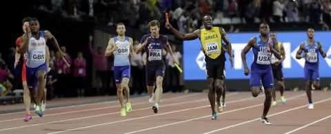 Jamaica's Usain Bolt, center, pulls up injured in the final of the Men's 4x100m relay during the World Athletics Championships in London Saturday, Aug. 12, 2017. At right is United States' Christian Coleman and left Britain's Nathaneel Mitchell-Blake who took the gold. (AP Photo/David J. Phillip)