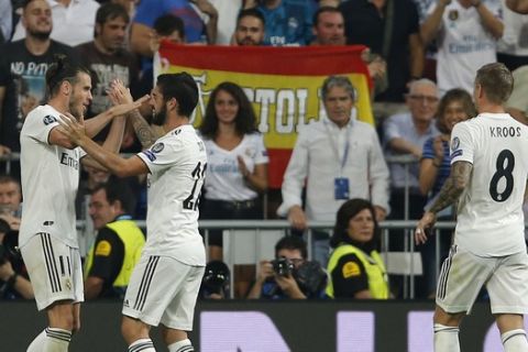 Real midfielder Gareth Bale, left, is congratulated by Real midfielder Isco after scoring his side second goal during a Group G Champions League soccer match between Real Madrid and Roma at the Santiago Bernabeu stadium in Madrid, Spain, Wednesday Sept. 19, 2018. (AP Photo/Paul White)