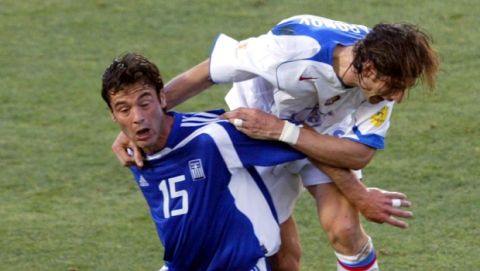 Greece's Zisis Vryzas (15), left, and Russia' Alexei Smertin compete for the ball during the Euro 2004 Group A soccer match between Greece and Russia at the Algarve Stadium in Faro, Portugal, Sunday, June 20, 2004. The other teams in Group A are Spain and Portugal. (AP Photo/Darko Vojinovic) **  FOR EDITORIAL USE ONLY NO WIRELESS COMMERCIAL OR PROMOTIONAL LICENSING PERMITTED **