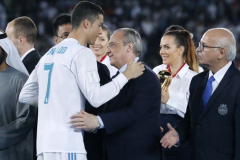 Real Madrid's Cristiano Ronaldo greets Real Madrid President Florentino Perez, center, and Gremio President Romildo Bolzan Jr., right, after winning the Club World Cup final soccer match between Real Madrid and Gremio at Zayed Sports City stadium in Abu Dhabi, United Arab Emirates, Saturday, Dec. 16, 2017. (AP Photo/Hassan Ammar)