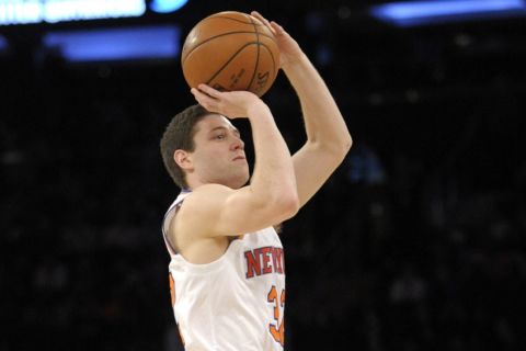 New York Knicks guard Jimmer Fredette hits a three-point shot during the fourth quarter of an NBA basketball game against the Toronto Raptors Monday, Feb. 22, 2016, at Madison Square Garden in New York. The Raptors won 122-95. (AP Photo/Bill Kostroun)