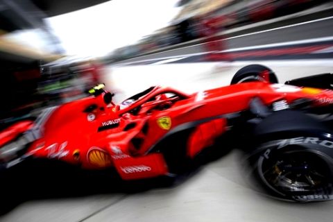 Ferrari driver Kimi Raikkonen of Finland steers his car out of his team's garage during the first practice session for the Chinese Formula One Grand Prix at the Shanghai International Circuit in Shanghai, Friday, April 13, 2018. (AP Photo/Andy Wong)