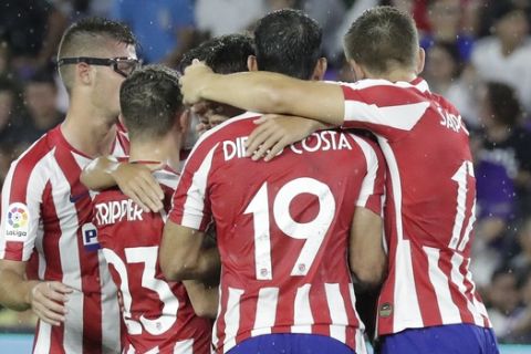Atletico Madrid forward Joao Felix is surrounded by teammates after scoring a goal against the MLS All-Stars in a soccer match Wednesday, July 31, 2019, in Orlando, Fla. (AP Photo/John Raoux)