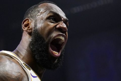 Los Angeles Lakers forward LeBron James celebrates after scoring and drawing a foul during the second half of an NBA basketball game against the Los Angeles Sunday, March 8, 2020, in Los Angeles. The Lakers won 112-103. (AP Photo/Mark J. Terrill)