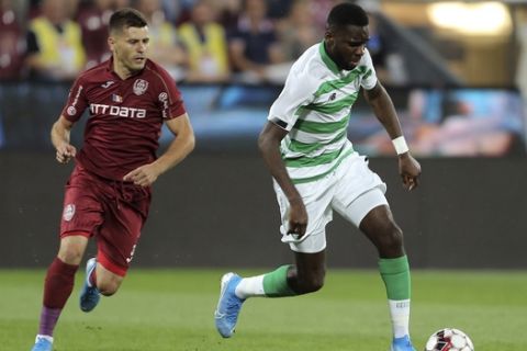 Celtic's Odsonne Edouard, right, challenges for the ball with CFR's Mihai Bordeianu, left, during the Champions League third qualifying round, first leg, soccer match between CFR Cluj and Celtic FC at the Constantin Radulescu stadium in Cluj, Romania, Wednesday, Aug. 7, 2019.(AP Photo/Mircea Rosca)