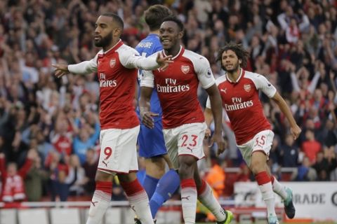 Arsenal's Alexandre Lacazette, left, celebrates after scoring the opening goal of the game during their English Premier League soccer match between Arsenal and Leicester City at the Emirates stadium in London, Friday, Aug. 11, 2017. (AP Photo/Alastair Grant)