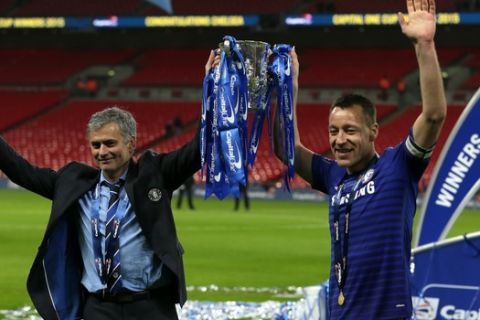 Chelsea's head coach Jose Mourinho, left and Chelsea's John Terry hold the trophy  after they won the English League Cup Final between Tottenham Hotspur and Chelsea at Wembley stadium in London, Sunday, March, 1, 2015. Chelsea won the match 2-0. (AP Photo/Tim Ireland)