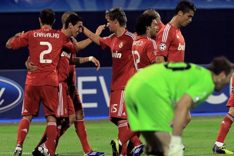 Real Madrid players (L) celebrate a goal during their UEFA Championship League football match against GNK Dinamo Zagreb in Zagreb, on September 14, 2011.   AFP PHOTO / STRINGER (Photo credit should read STRINGER/AFP/Getty Images)