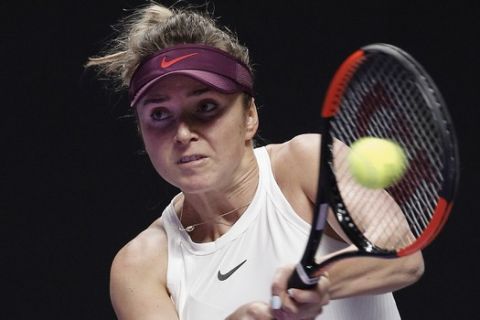 Elina Svitolina of Ukraine hits a return shot against Ashleigh Barty of Australia during the WTA Finals Tennis Tournament at the Shenzhen Bay Sports Center in Shenzhen, China's Guangdong province, Sunday, Nov. 3, 2019. (AP Photo/Andy Wong)
