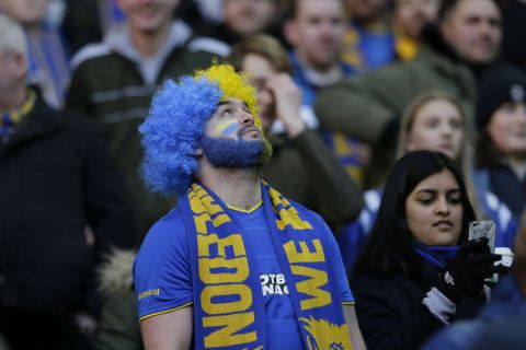 A Wimbledon fan with a scarf before the English FA Cup third round match between Tottenham Hotspur and AFC Wimbledon at Wembley Stadium in London, Sunday Jan. 7, 2018. (AP Photo/Tim Ireland)