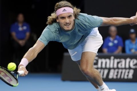 Greece's Stefanos Tsitsipas makes a forehand return to Switzerland's Roger Federer during their fourth round match at the Australian Open tennis championships in Melbourne, Australia, Sunday, Jan. 20, 2019. (AP Photo/Mark Schiefelbein)