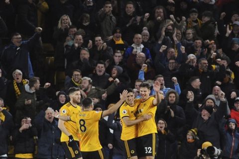 Wolverhampton players and fans celebrate their second goal during the English Premier League soccer match between Wolverhampton Wanderers and Manchester United at the Molineux Stadium in Wolverhampton, England, Tuesday, April 2, 2019. (AP Photo/Rui Vieira)