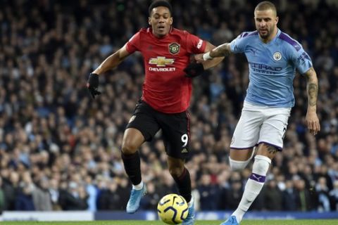 Manchester United's Victor Lindelof, left, duels for the ball with Manchester City's Kyle Walker during the English Premier League soccer match between Manchester City and Manchester United at Etihad stadium in Manchester, England, Saturday, Dec. 7, 2019. (AP Photo/Rui Vieira)
