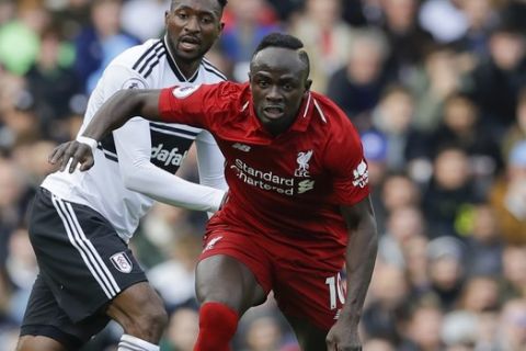 Liverpool's Sadio Mane, right, is challenged by Fulham's Andre-Frank Zambo Anguissa during the English Premier League soccer match between Fulham and Liverpool at Craven Cottage stadium in London, Sunday, March 17, 2019. (AP Photo/Kirsty Wigglesworth)