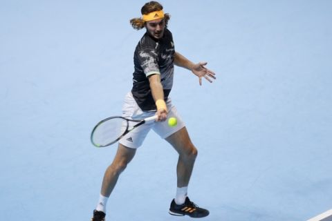 Stefanos Tsitsipas of Greece plays a return to Daniil Medvedev of Russia during their ATP World Tour Finals singles tennis match at the O2 Arena in London, Monday, Nov. 11, 2019. (AP Photo/Kirsty Wigglesworth)