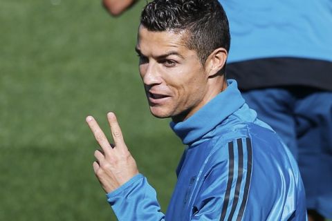 Real Madrid's Cristiano Ronaldo signals during a training session in Madrid, Spain, Tuesday, Sept. 12, 2017. Real Madrid will play APOEL Nikosia Wednesday in a Group H Champions League soccer match. (AP Photo/Paul White)