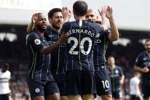 Manchester City's Bernardo Silva, center, celebrates after scoring the opening goal during the English Premier League soccer match between Fulham and Manchester City at Craven Cottage stadium in London, Saturday, March 30, 2019. (AP Photo/Alastair Grant)
