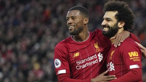 Liverpool's Mohamed Salah, right, celebrates with Liverpool's Georginio Wijnaldum after scoring his sides third goal during the English Premier League soccer match between Liverpool and Southampton at Anfield Stadium, Liverpool, England, Saturday, February 1, 2020. (AP Photo/Jon Super)