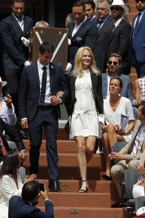 U.S. actress Nicole Kidman and Tony Estanguet, French slalom canoeist and triple Olympic champion, walk down the stairs to present the trophy prior to the men's final match between Stan Wawrinka and Spain's Rafael Nadal at the French Open tennis tournament at the Roland Garros stadium, in Paris, France, Sunday, June 11, 2017. (AP Photo/Petr David Josek)
