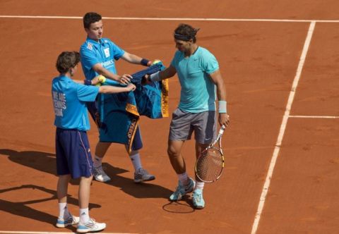 May 31, 2014; Paris, France; Rafael Nadal (ESP) retrieves  towels during his match against Leonardo Mayer (ARG, not pictured) on day seven at the 2014 French Open at Roland Garros. Mandatory Credit: Susan Mullane-USA TODAY Sports