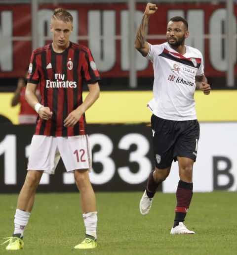 Cagliari's Joao Pedro, right, celebrates after scoring during a Serie A soccer match between AC Milan and Cagliari, at the San Siro stadium in Milan, Italy, Sunday, Aug. 27, 2017. (AP Photo/Luca Bruno)