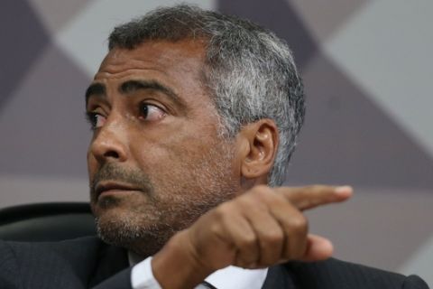 Senator Romario Faria, a former Barcelona soccer star, attends a parliamentary commission investigating allegations of corruption in the Brazilian football confederation (CBF), at the Senate in Brasilia, Brazil, Wednesday, Dec. 16, 2015. An investigation by American and Swiss officials has snared the last three presidents of the CBF, all of whom have been indicted: Marco Polo del Nero and his predecessors Jose Maria Marin and Ricardo Teixeira. (AP Photo/Eraldo Peres)