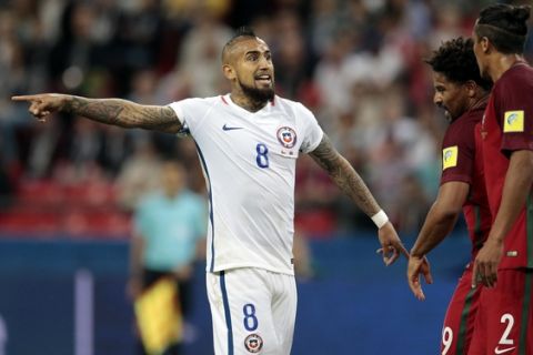 Chile's Arturo Vidal gestures to Portugal's Bruno Alves, right, during the Confederations Cup, semifinal soccer match between Portugal and Chile, at the Kazan Arena, Russia, Wednesday, June 28, 2017. (AP Photo/Ivan Sekretarev)
