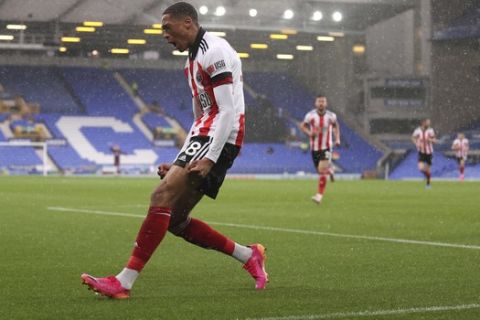 Sheffield United's Daniel Jebbison celebrates after scoring his side's opening goal during the English Premier League soccer match between Everton and Sheffield United at Goodison Park in Liverpool, England, Sunday, May 16, 2021. (Alex Pantling/Pool via AP)