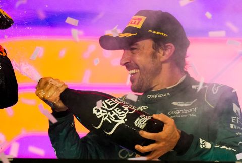 Aston Martin driver Fernando Alonso of Spain sprays with champagne /'1' at the winners podium after the Saudi Arabia Formula One Grand Prix at the Jeddah corniche circuit in Jeddah, Saudi Arabia, Sunday, March 19, 2023. (AP Photo/Luca Bruno)