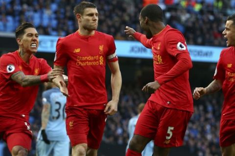 Liverpool's James Milner, center, celebrates after scoring the opening goal during the English Premier League soccer match between Manchester City and Liverpool at the Etihad Stadium in Manchester, England, Sunday March 19, 2017. (AP Photo/Dave Thompson)