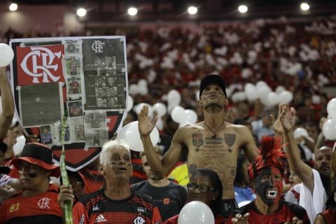 Fans pay homage to the 10 teenage players killed by a fire at the Flamengo training center last Friday, during a homage to the boys ahead of a soccer match between Flamengo and Fluminense, at the Maracana Stadium in Rio de Janeiro, Brazil, Thursday, Feb. 14, 2019. (AP Photo/Leo Correa)